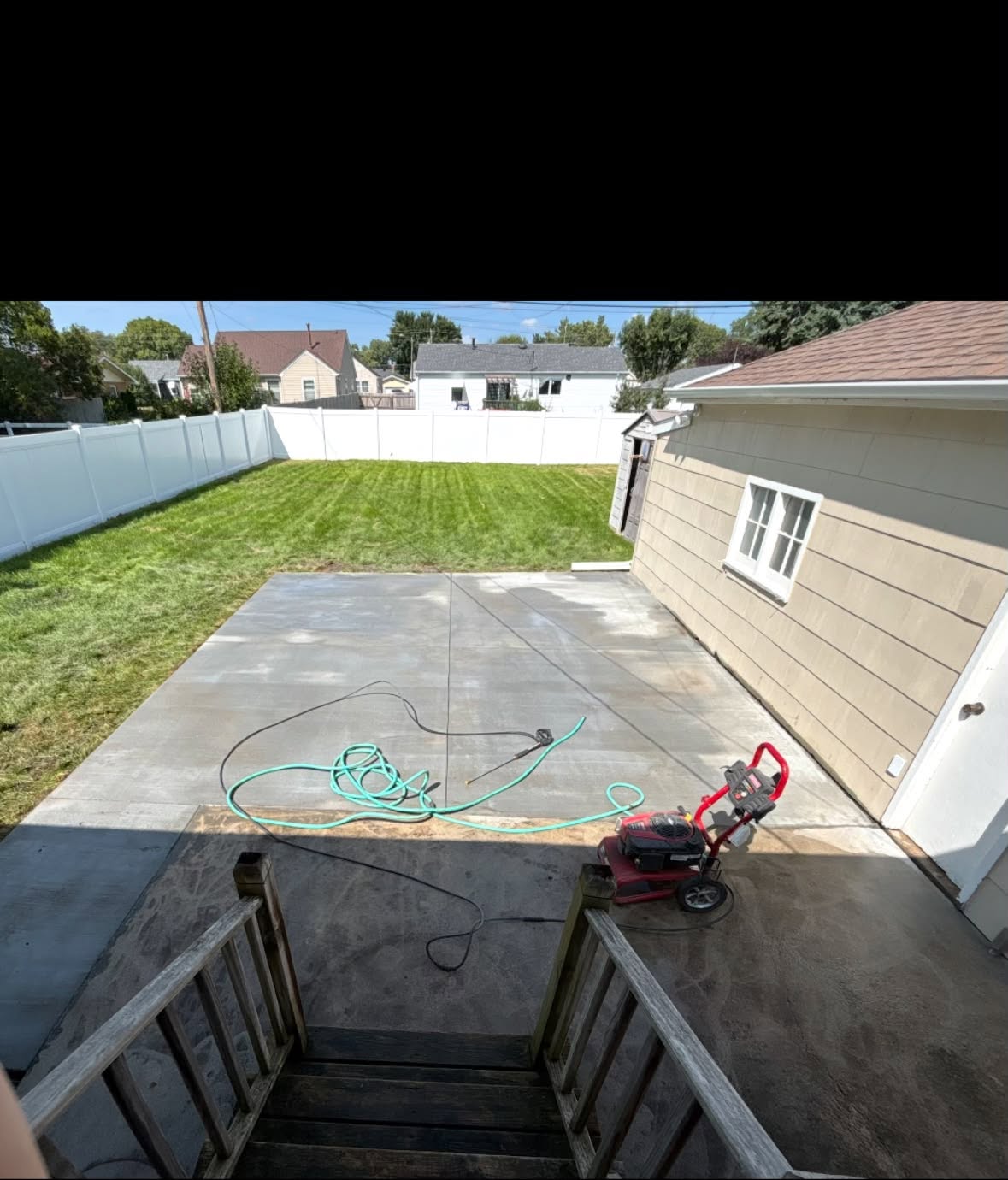 Freshly finished concrete patio behind a residential home